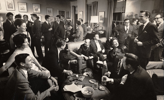 George Plimpton (bottom left) and Truman Capote (sitting far left on couch) at a cocktail party in Plimpton’s apartment, 1963, as seen in “American Masters: Plimpton! Starring George Plimpton as Himself.” (Photo Credit: Cornell Capa/Laemmle Zeller Films)